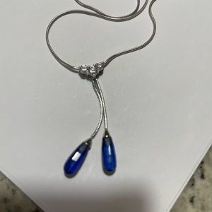 14 karat white gold lariat necklace with blue sapphire colored stones
